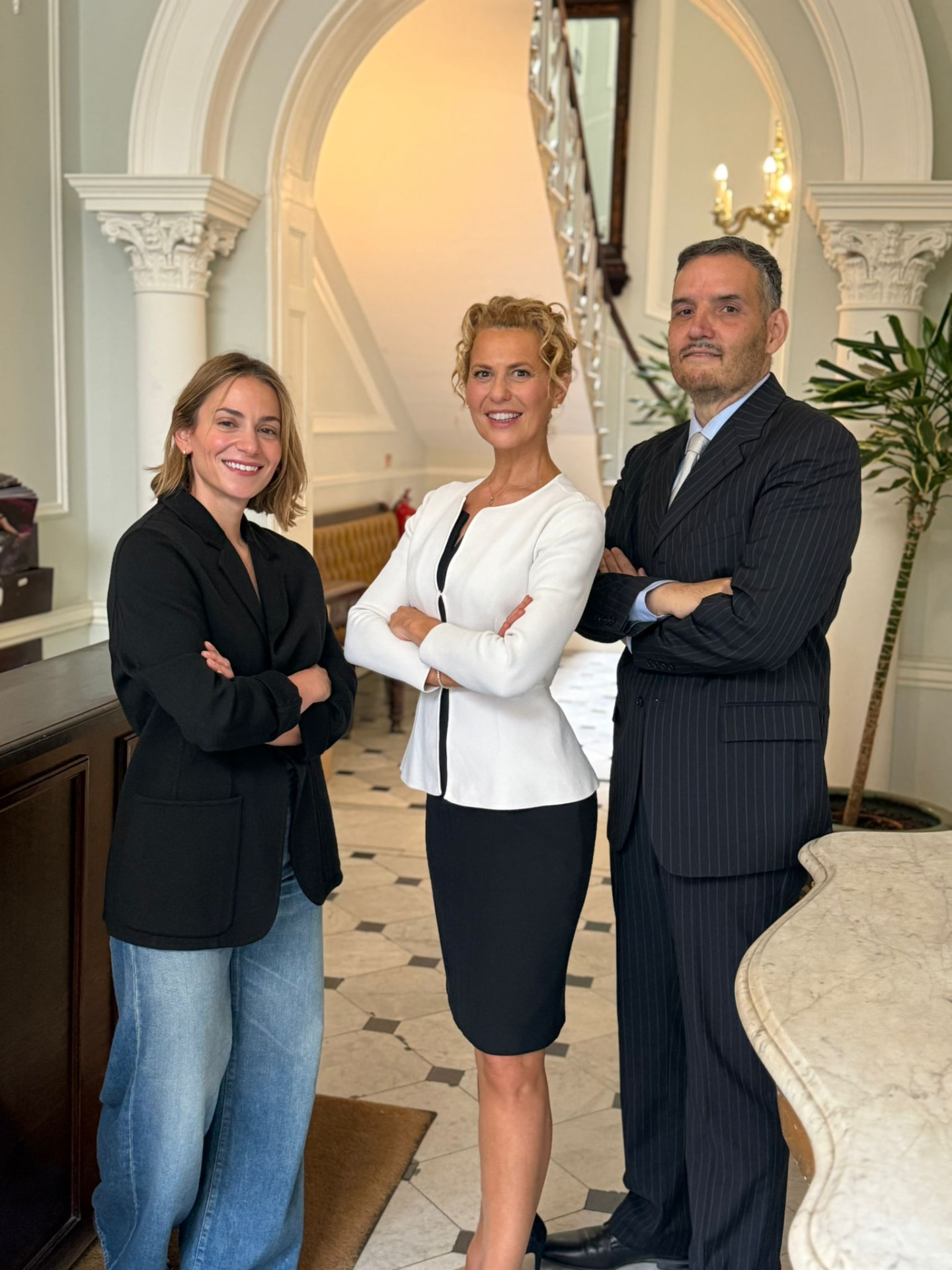 Three members of the clinic team standing in the reception hall of the Harley Street practice