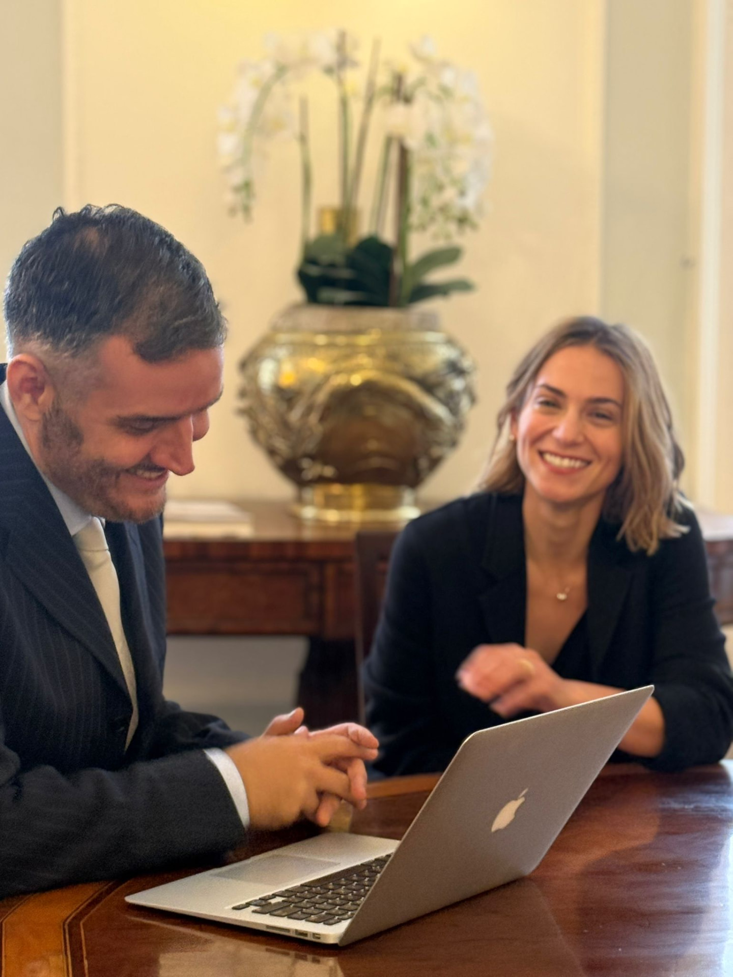 Two members of the clinic team reviewing a case together at a desk