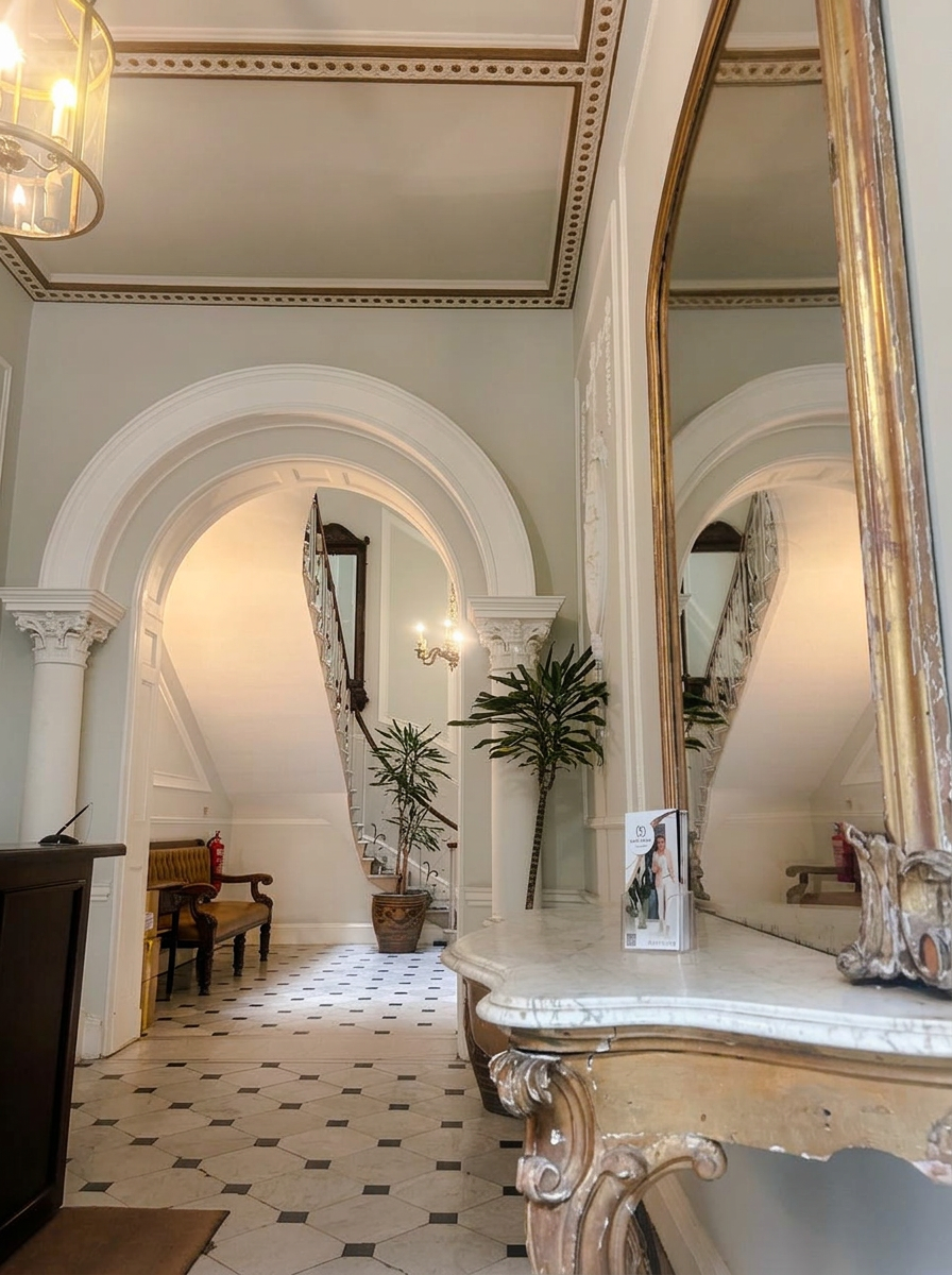 Entrance hall of the clinic at 94 Harley Street, with period plasterwork and staircase